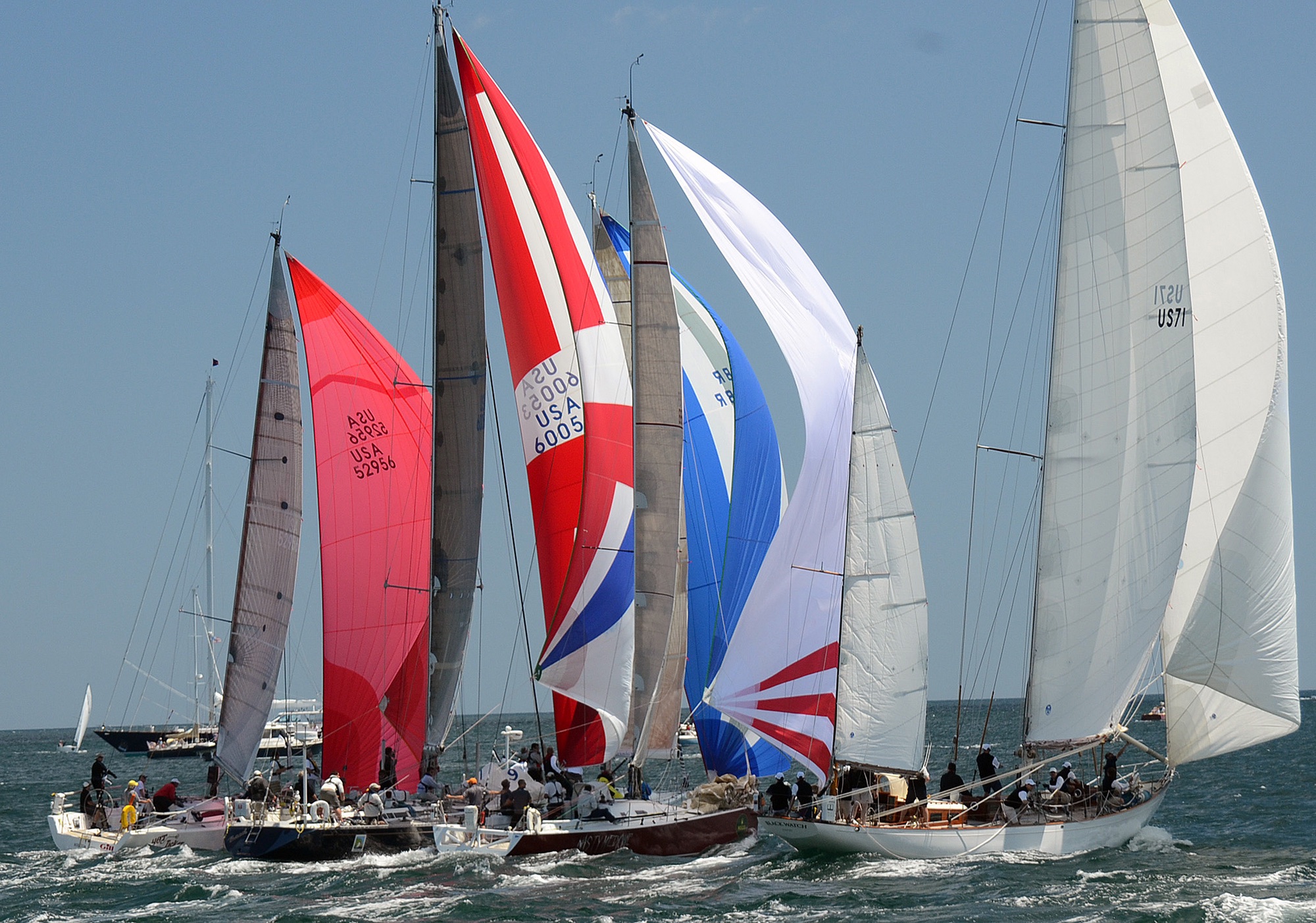 In a northerly breeze, the fleet starts under colorful spinnakers as it did in 2012 with modern boats lined up next to the white sails of Black Watch, which celebrates its 80th season with the 2108 race (Talbot Wilson photo)
