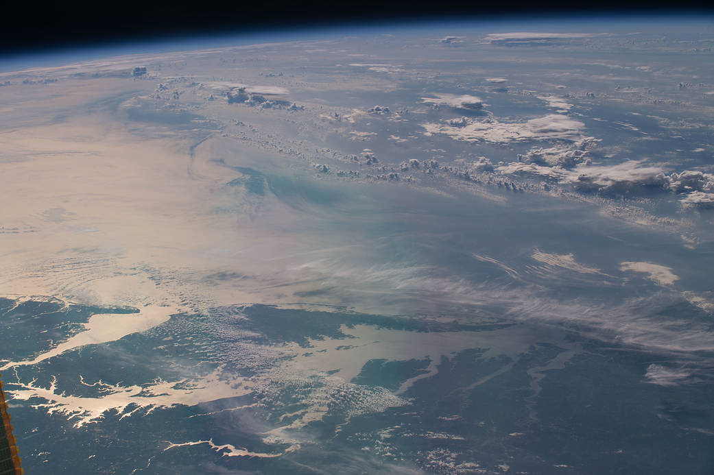 On July 21, 2016, Expedition 48 Commander Jeff Williams of NASA shared this photograph of sunglint illuminating the waters of the Chesapeake Bay, writing, "Morning passing over the Chesapeake Bay heading across the Atlantic." Courtesy of NASA