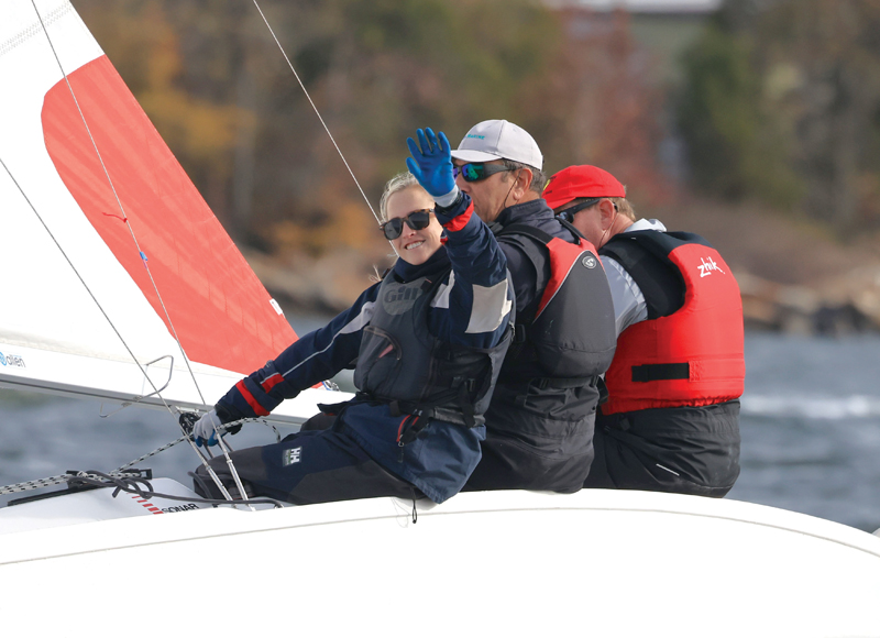 SpinSheet Racing Team sailor waves to camera