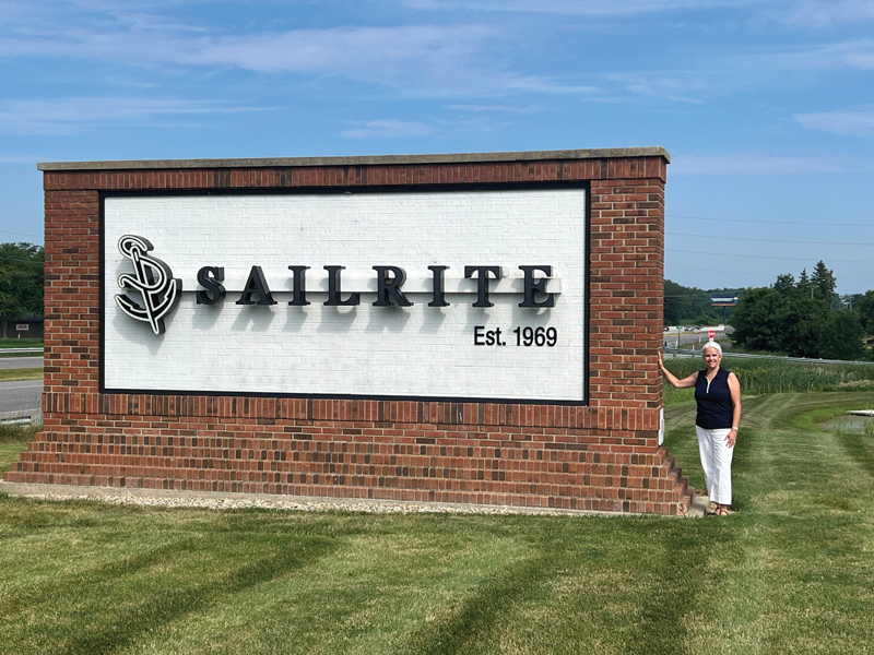 woman next to Sailrite sign