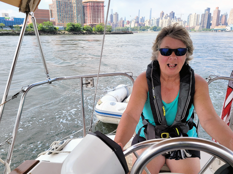 woman steering sailboat NYC