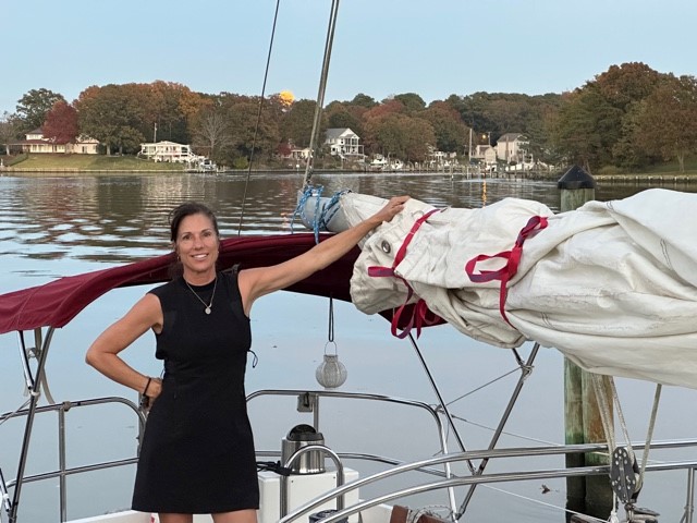 Woman standing in her sailboat's cockpit