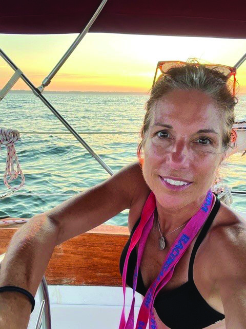 Woman on a sailboat at sunset