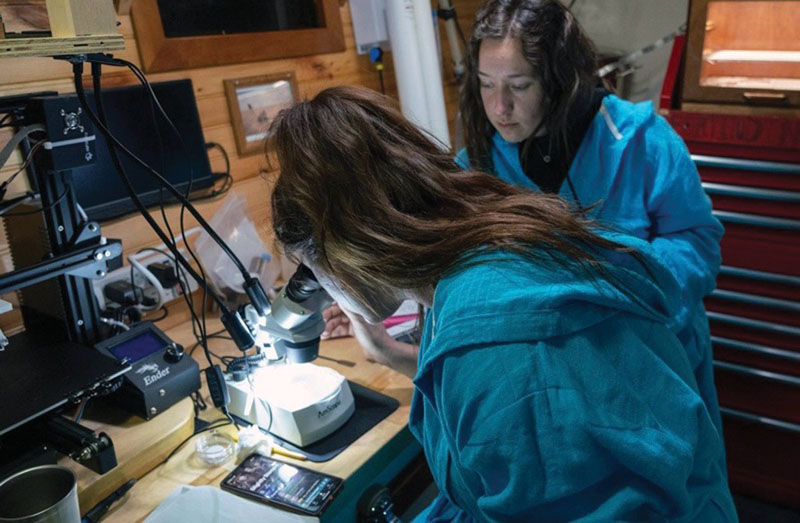 two researchers in an onboard research lab