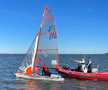 29er skiff sailboat and coach boat on the water