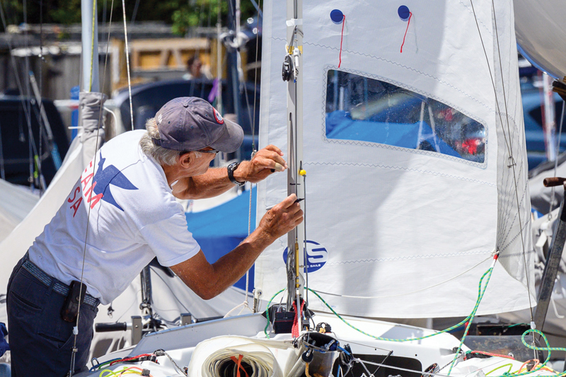 Dinghy racer marking sailboat mast