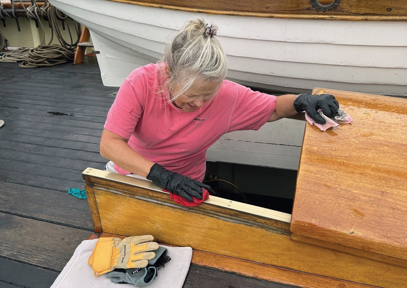 guest crew polishing brightwork on Pride of Baltimore II